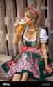 pretty-young-german-oktoberfest-blonde-woman-in-a-dirndl-dress-with-beer-T2DN08-2024987489