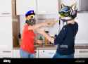 woman-throwing-cup-of-coffee-on-her-husband-KRYK68-3885200745