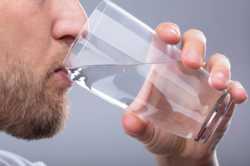 closeup-man-drinking-glass-water-260nw-1239383374