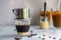 Vietnamese_coffee_with_condensed_milk_in_glass_cups_with_traditional_metal_coffee_maker_phin_on_white_table_9dc66cf3-d3f9-4c80-a5bd-aa48f44697bd_600x.jpg