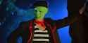 jim-carrey-as-the-mask-in-his-french-outfit-leaning-on-a-treek-trunk-from-the-mask-movie