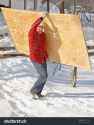 stock-photo-man-carrying-a-sheet-of-plywood-24190348