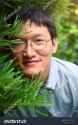 stock-photo-chinese-man-wearing-eye-glasses-with-natural-green-plant-background-1037255302[1]