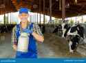 positive-farmer-working-dairy-farm-carrying-small-milk-can-near-open-stall-cows-positive-farmer-carrying-milk-can-open-250940580-3934635721