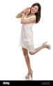 asian-woman-looking-happy-kicking-one-leg-behind-her-E0D275