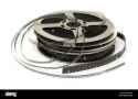 stack-of-old-movie-films-on-metal-reel-on-white-BAR6H0-774160374