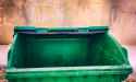 close-up-of-green-open-trash-dumpster