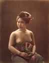 Topless_sitting_woman_holding_fan,_Japan,_circa_1880