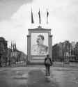 A_German_civilian_looks_at_a_large_poster_portrait_of_Stalin_on_the_Unter-den-Linden_in_Berlin,_3_June_1945._BU8572