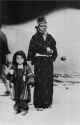 A_mother_and_her_child_leaving_the_first-aid_station_after_receiving_rations_-_1945-08-10_morning