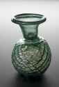 An ancient Roman green glass dropper bottle for storing expensive oils used for cleaning the body and for medical treatments, c. 100-500 CE