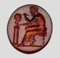 Magnificent Roman carnelian with the artist’s image while painting a woman’s bust. The object is dated to the 1st-3rd century CE and is only 1.2 cm long.