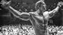 Arnold Schwarzenegger posing in the Mr. Olympia competition (1974) gray
