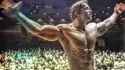 Arnold Schwarzenegger posing in the Mr. Olympia competition (1974) color