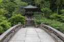 Stone_bridge_leading_to_a_cemetery_surrounded_by_trees_in_the_compounds_of_Chion-in_Kyoto_Japan