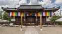Exterior_facade_of_Kannon_Hall_Buddhist_temple_with_Goshikimaku_Buddhist_flags_Ninna-ji_Kyoto_Japan