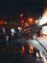 rain is falling on street at night