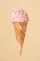 cornet-ice-cream-with-strawberry-scoop-colorful-surface