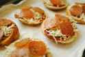 tiny pizzas before baking