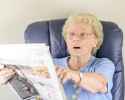 old-woman-reading-newspaper-26081526