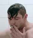 defeated-man-smoking-cigarette-in-shower