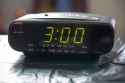 black-digital-alarm-radio-clock-alarm-radio-clock-indicating-time-to-wake-up-digital-clock-closeup-displaying-o-clock-125644459