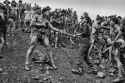 Brazilian_mine_laborers_confront_a_policeman_1986_policeman_is_carrying_Mauser_Mosquefal_M968