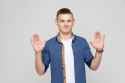 hands-up-young-boy-wearing-white-tshirt-and-blue-shirt-looking-at-camera-and-give-up-1512167564