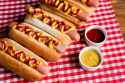 stock-photo-delicious-hot-dogs-ketchup-mustard-checkered-napkin-wooden-table