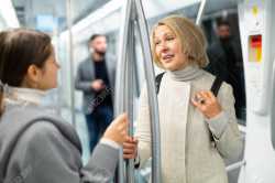 134239038-two-women-passengers-talking-in-subway-car-on-way-to-work[1]