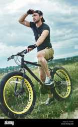 handsome-stylish-guy-cycling-at-the-mountains-he-used-special-mountain-bike-amazing-sky-PTTRXR