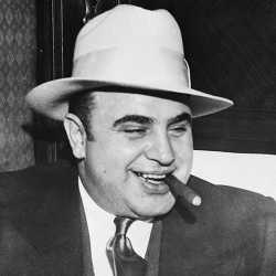 -al-capone-smokes-a-cigar-on-the-train-carrying-him-to-the-federal-penitentiary-in-atlanta-where-he-will-start-serving-an-eleven-year-sentence