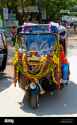 tuk-tuk-the-indian-popular-taxi-full-decorated-with-colorful-flowers-indian-style-chitradurga-karnataka-india-R7YCCP