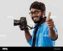 professional-photographer-having-dslr-camera-taking-pictureindian-man-photography-enthusiast-taking-photo-while-standing-on-blu-2M6WR6D