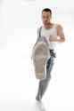 man-wearing-gray-pants-white-tank-top-kicks-his-leg-up-air-stock-photo-man-wearing-gray-pants-333702497