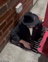 79782601-12941611-A_man_is_seen_emerging_from_the_tunnels_beneath_the_synagogue-a-5_1704805470251