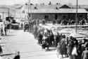 1280px- Auschwitz Birkenau_a_group_of_Jews_walking_towards_the_gas_chambers_and_crematoria in May-June 1944. Gate on the left leads to area BI, the oldest part of the camp