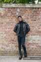 focused_203736830-stock-photo-man-standing-against-brick-wall