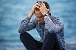 Man in Blue and Brown Plaid Dress Shirt Touching His Hair photographed by Nathan Cowley 