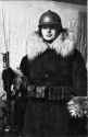 Italian woman wearing an Adrian helmet and a fur coat, carrying a Vetterli Vitali rifle with bayonet during the Great War