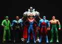 Superman cosplaying as Amazo, Superman with Roy Orbison glasses, Black Lightning, Atom, and Riddler