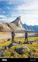 backpackers-stand-in-awe-of-mount-thor-baffin-island-canada-2F7E49G