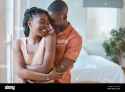 young-affectionate-african-american-couple-embracing-while-relaxing-in-the-bedroom-at-home-happy-boyfriend-hugging-girlfriend-from-behind-while-2T4K4Y4