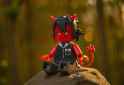 sfw, outdoors, forest, dappled sunlight, sunset, rock, {{{{ Lego figure, photo s-904679150