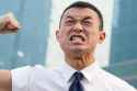angry asian man about to punch himself in the face