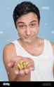 man-offering-handful-of-pills-ABN9MK