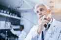 scientist-thinking-formula-on-glass-600nw-2327435879