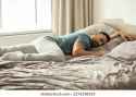 relaxed-man-sleeping-on-stomach-260nw-2276338365