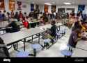 african-american-male-student-sits-alone-at-table-during-lunch-in-CRRPDW