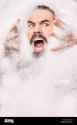 man-with-moustache-covered-in-bubbles-pulling-face-GJ2J5Y-1541350642